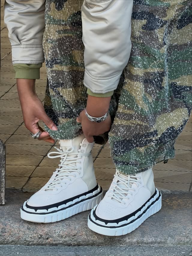 Ayke (@bookof_ayke) styles the @khola.tm Exterior Boot in Fossil Tan /// A modular, glue-less shoe system created for creativity, longevity, and a more sustainable future..Available in unisex sizing US 6–13 at unitednude.com. Use code AYKE10 for 10% off sitewide..#unitednude #SS26 #footweardesign #sustainablefashion #sustainableshoes by @unitednude