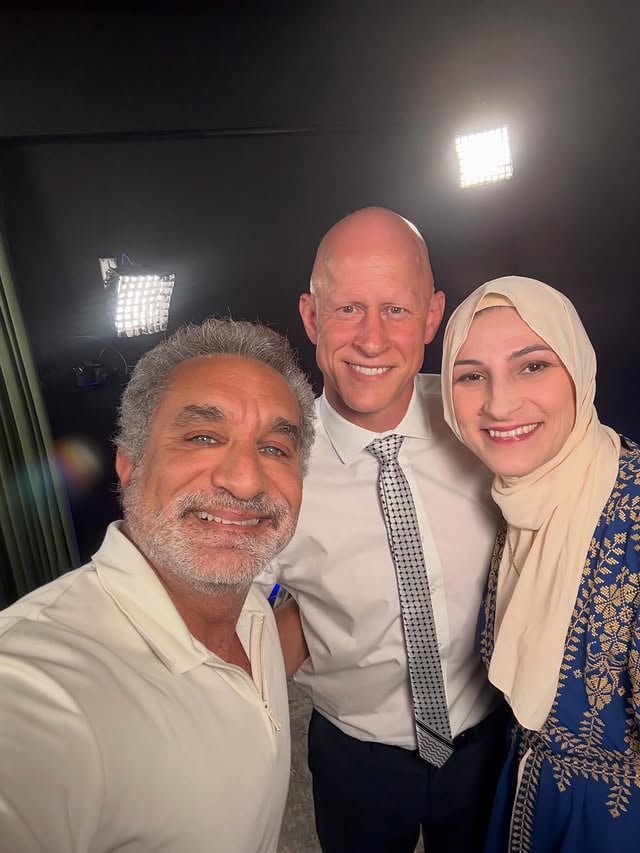 Remember how they broke the arm of a Marine because he stood up protesting going to war for Israel ? Well I finally met him and his lovely wife . We had an incredible interview . Out soon . Also , nice tie ! @brianmcginnisnc @realtordeeali by @bassem
